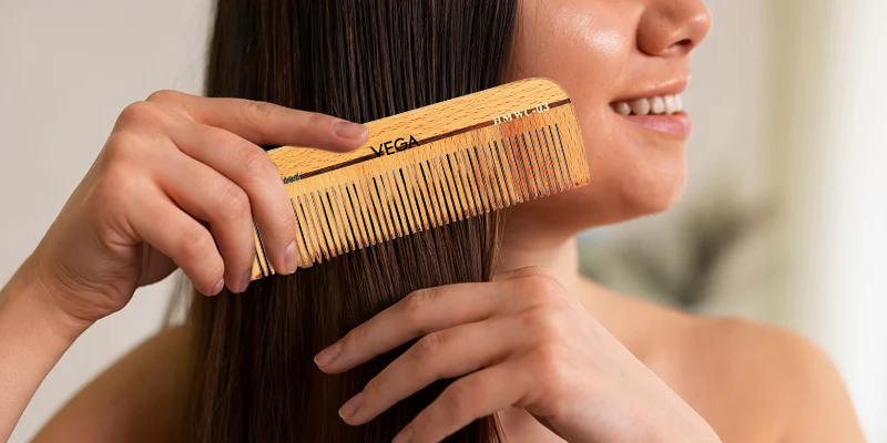 model combing hair with a neem comb